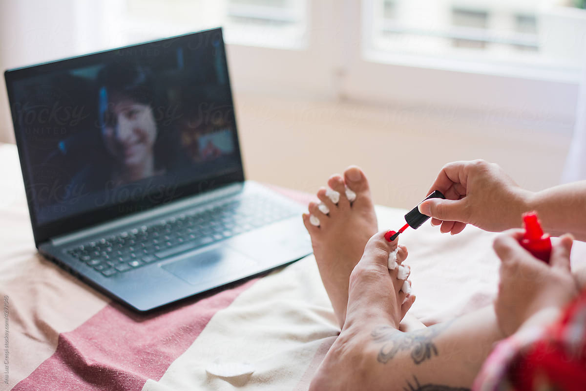 A video call with a friend while painting nails