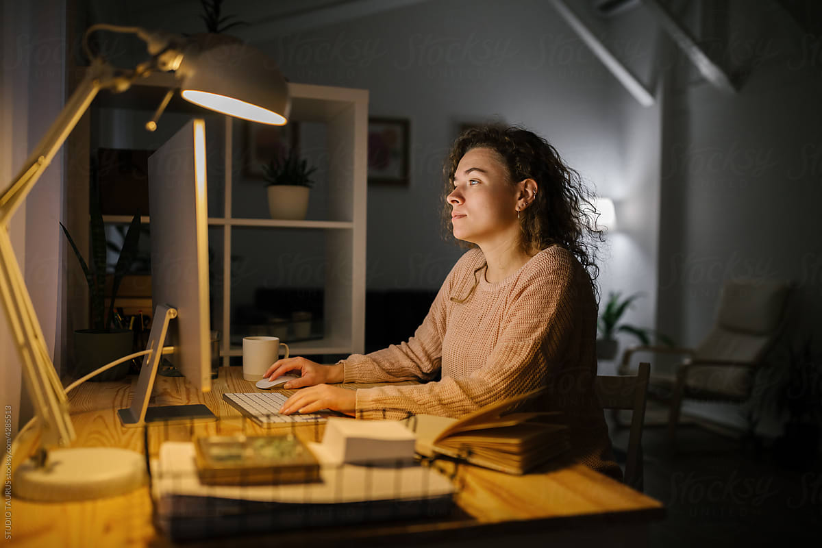 College woman studying at home during night