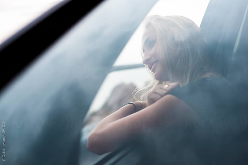 Young woman traveling by car