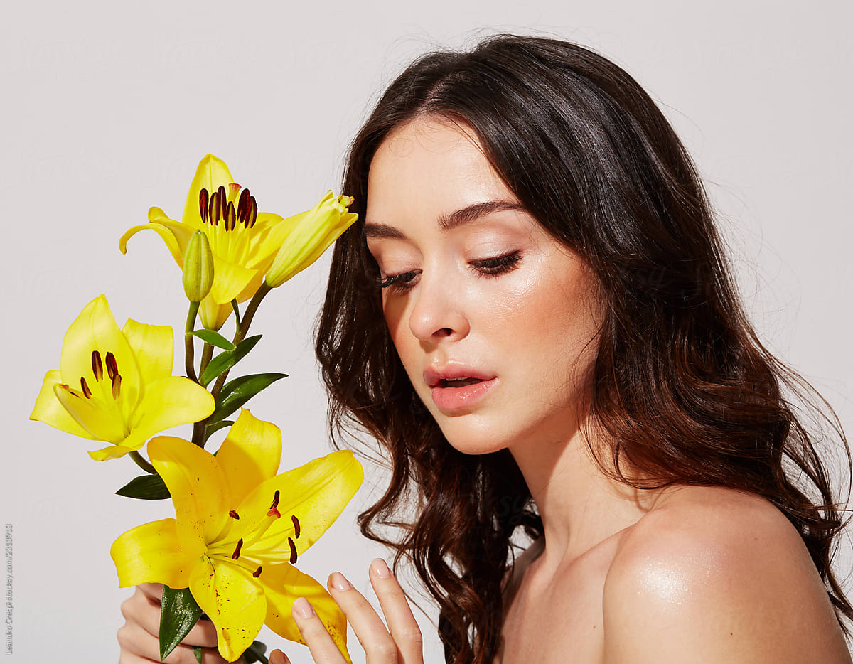 Beauty portrait young woman with yellow flower