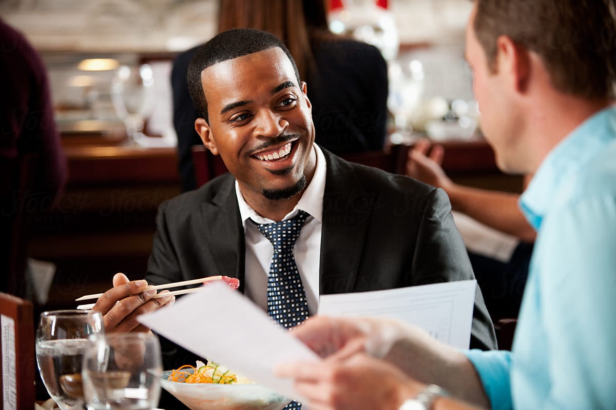 Sushi: Businessman Laughing While Eating and Doing Business