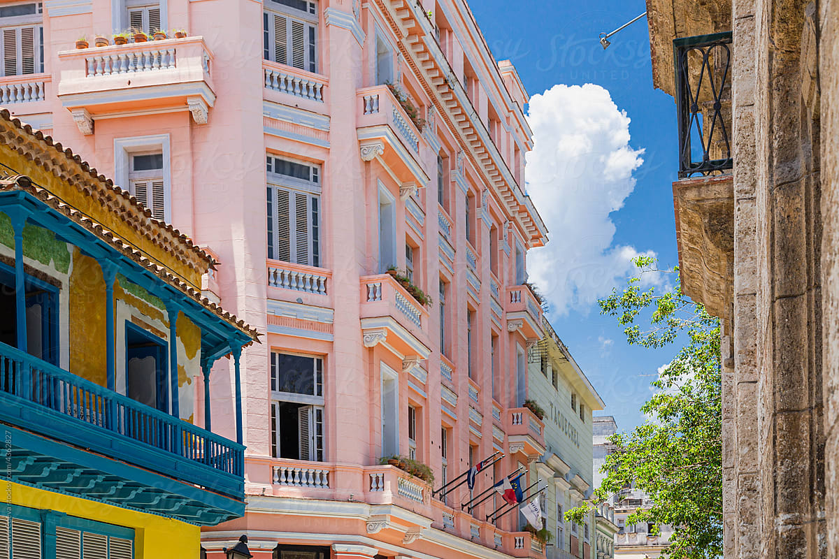 Perspective of a pink building  and blue balcony