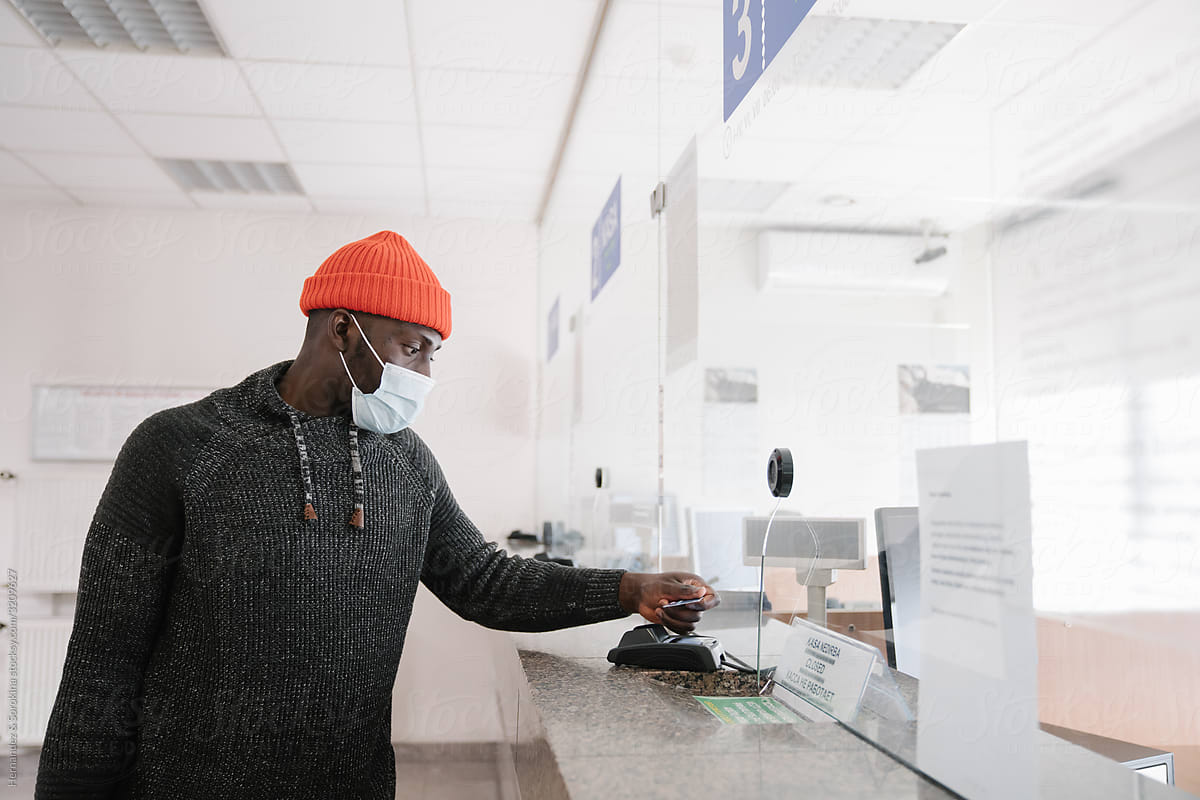 Black Man Wearing Face Mask Using Credit Card To Pay
