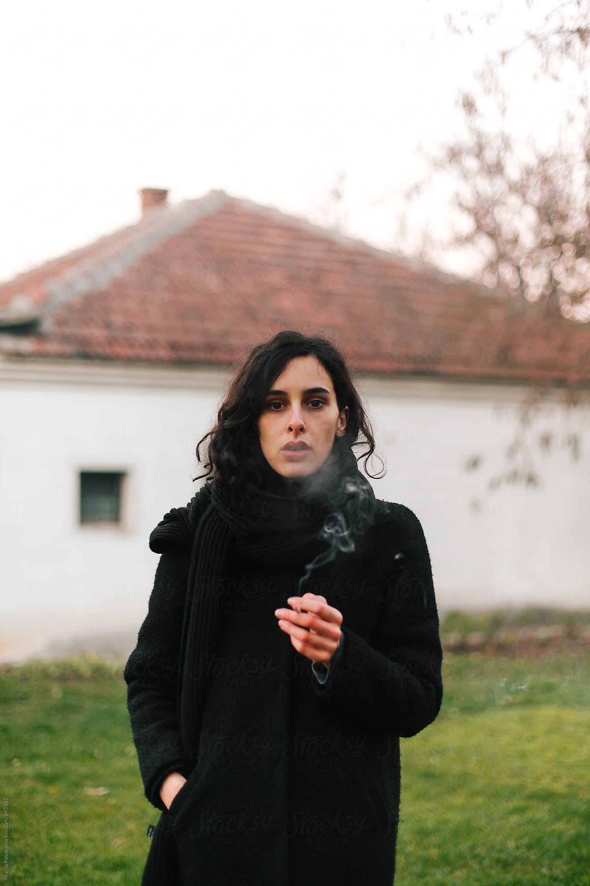 Pretty Woman Blowing A Cigarette Smoke By Stocksy Contributor Marija