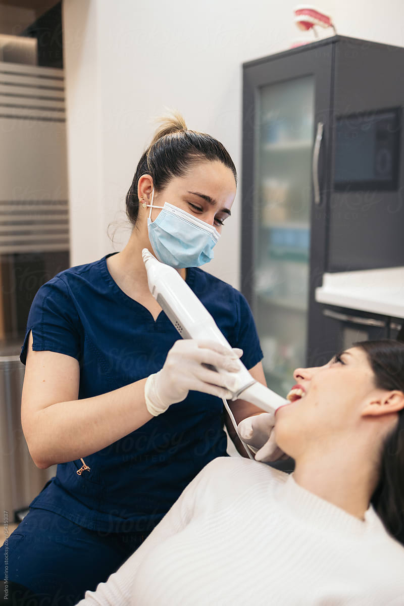 Dentist doing an intraoral 3D scanner to a patient