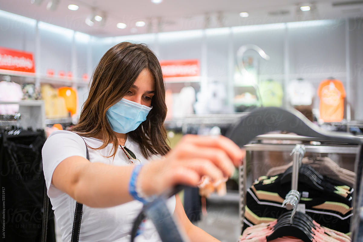 Girl With Mask Doing Shopping And Checking Clothes.