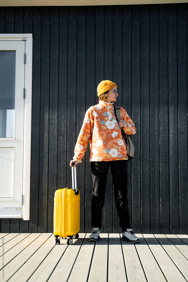 Stylish traveler, yellow hat, eco hotel, ready for a nature road trip