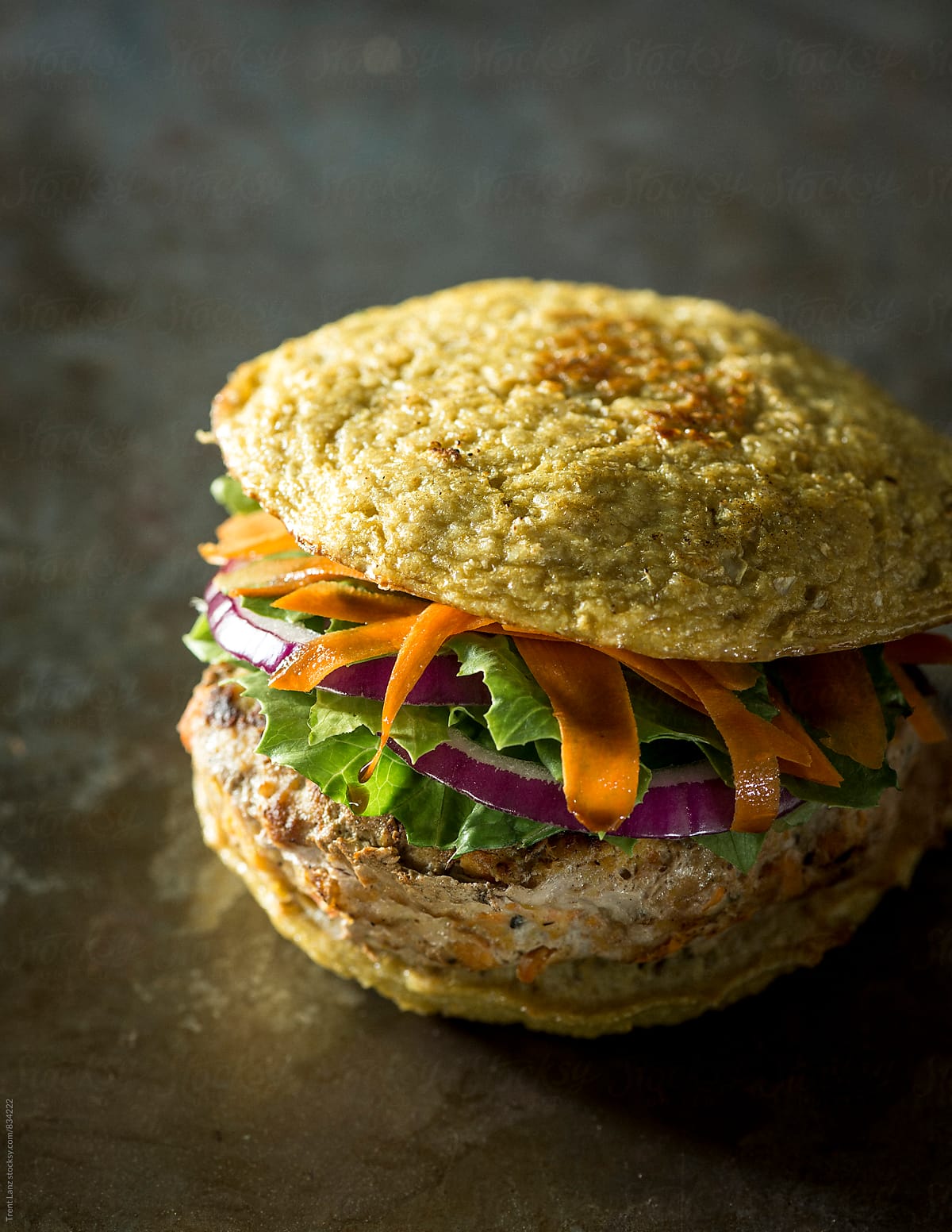 Paleo turkey burger with lettuce carrot and red onion