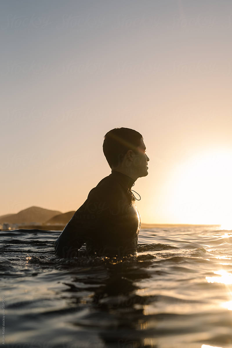 Portrait captures the tranquil outline of a surfer serenely floating