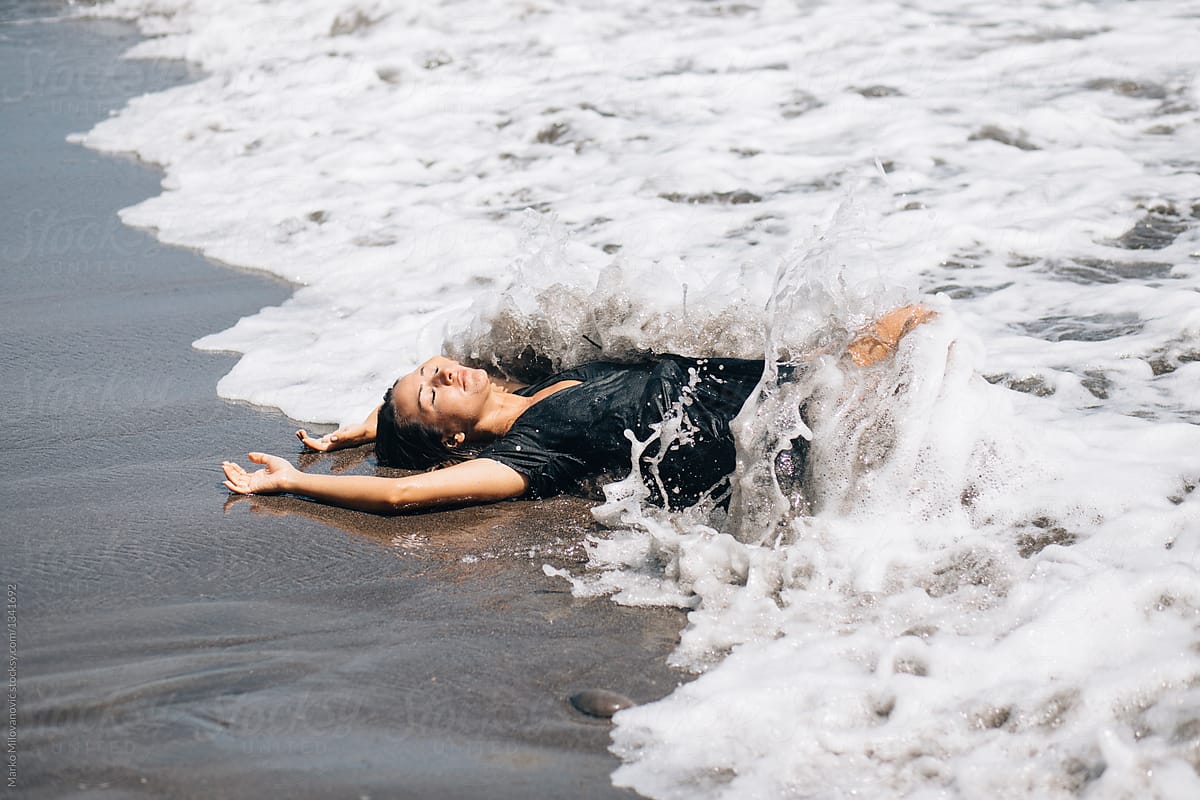 Woman Laying On The Black Sand Beach By Stocksy Contributor Marko Stocksy 3598