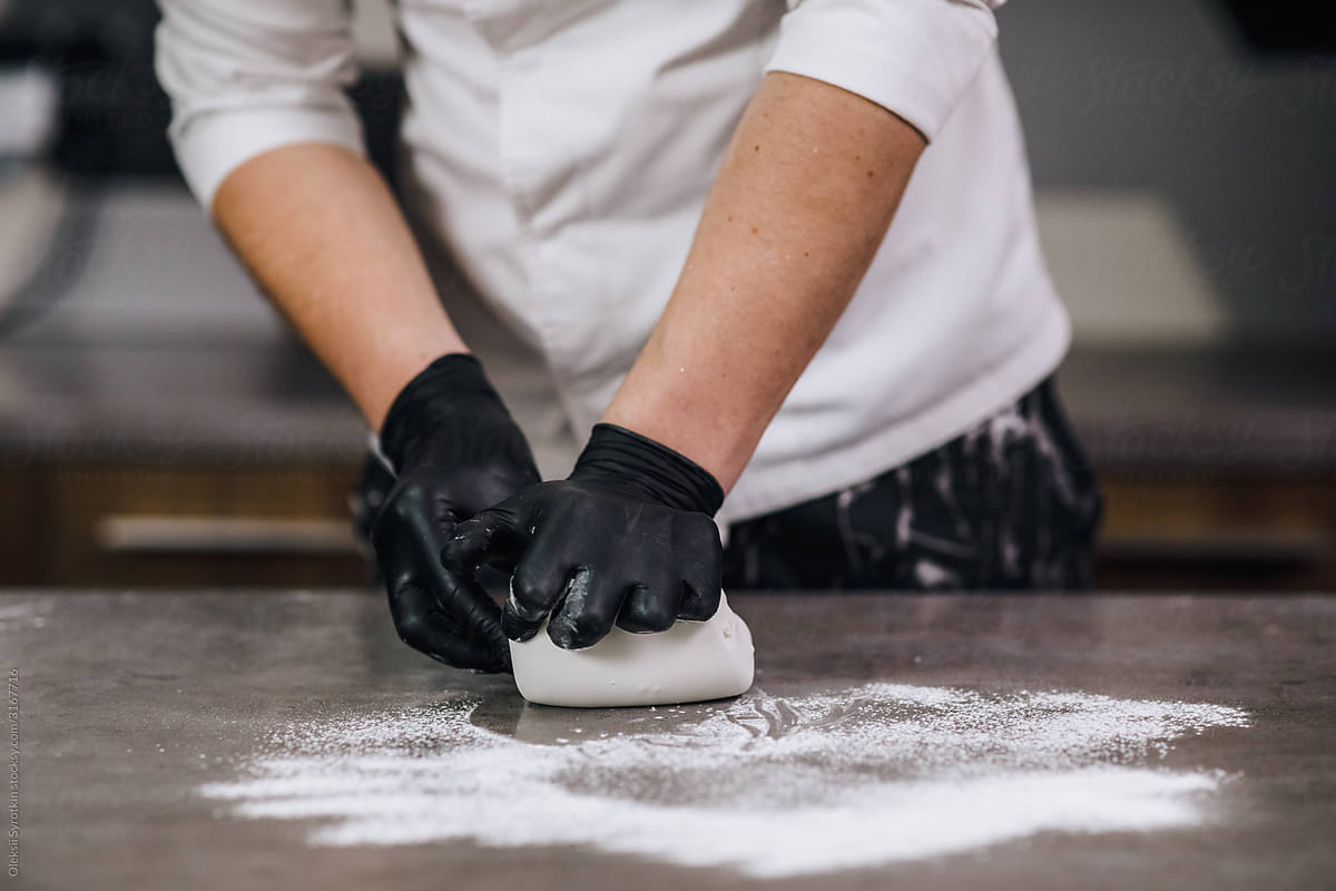 Baker creating dough for cake