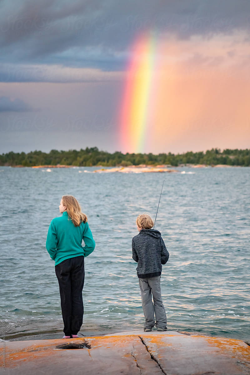 Boy and Girl With Storm Rainbow on Sea Kayak Camping Trip to Georgian Bay Canada