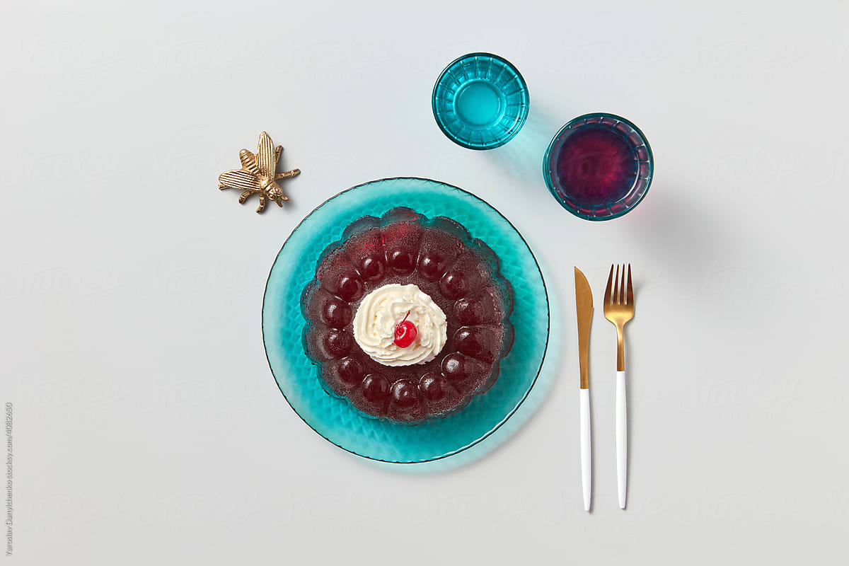 Jelly dessert near cutlery and drinks