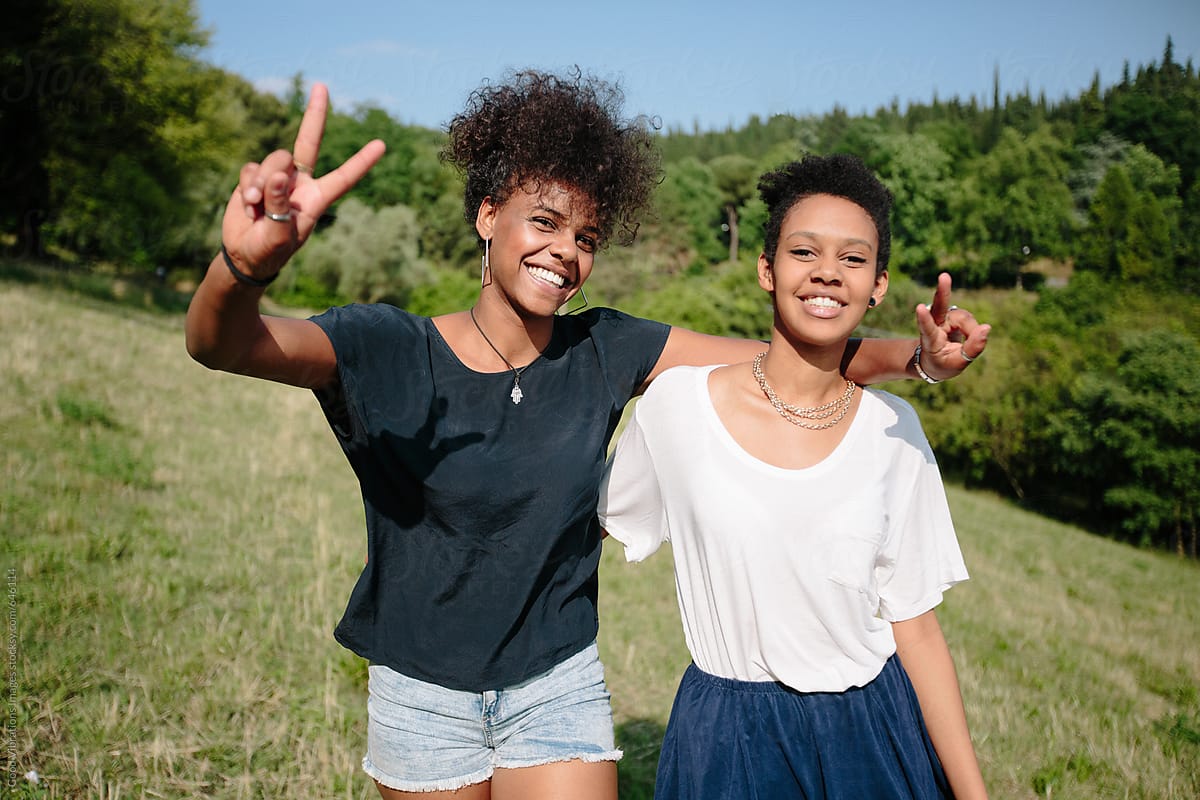 Two Smiling Friends Outdoors By Stocksy Contributor Vero Stocksy