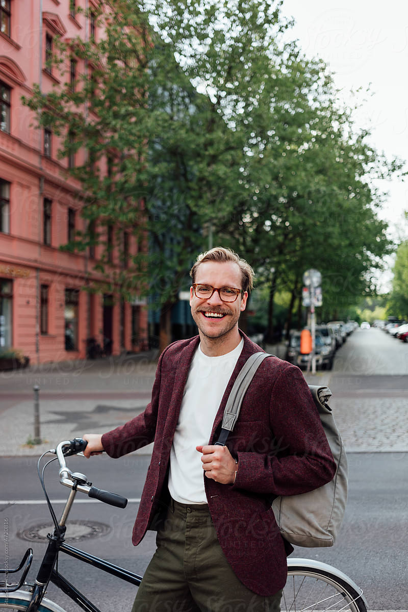 Man with Bicycle Outdoors in City