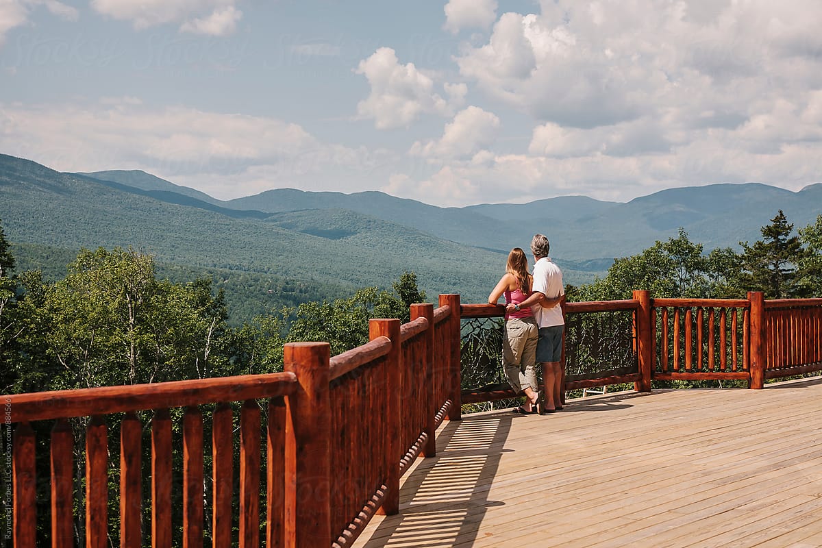 Landscape view from Porch in Mountains of Maine in summer with couple
