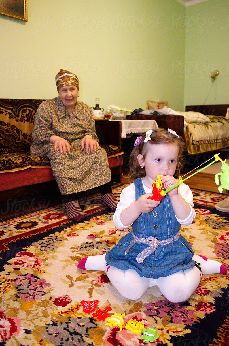 A little granddaughter with her great grandmother in the room