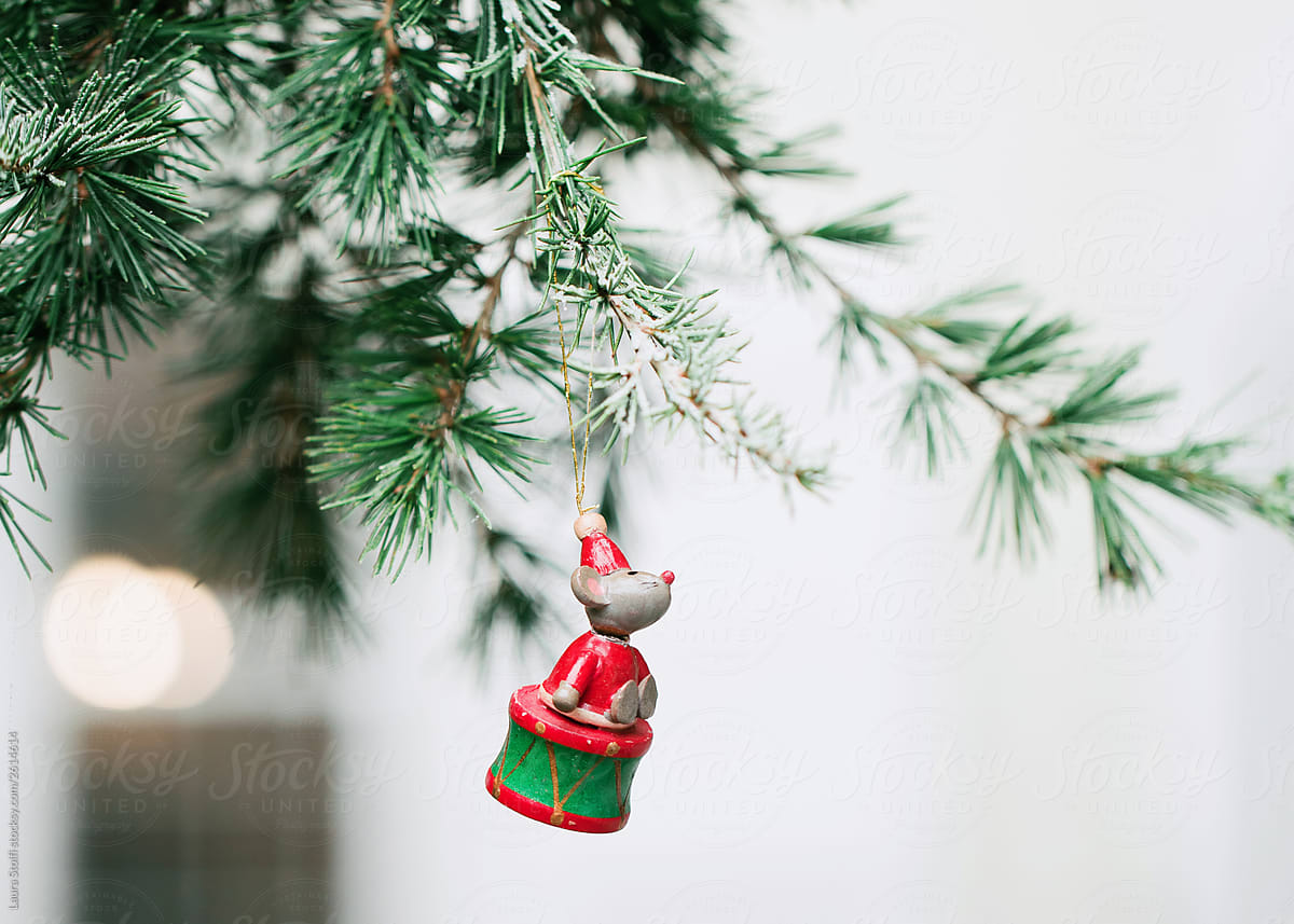 A wooden mouse Santa hangs from Christmas tree