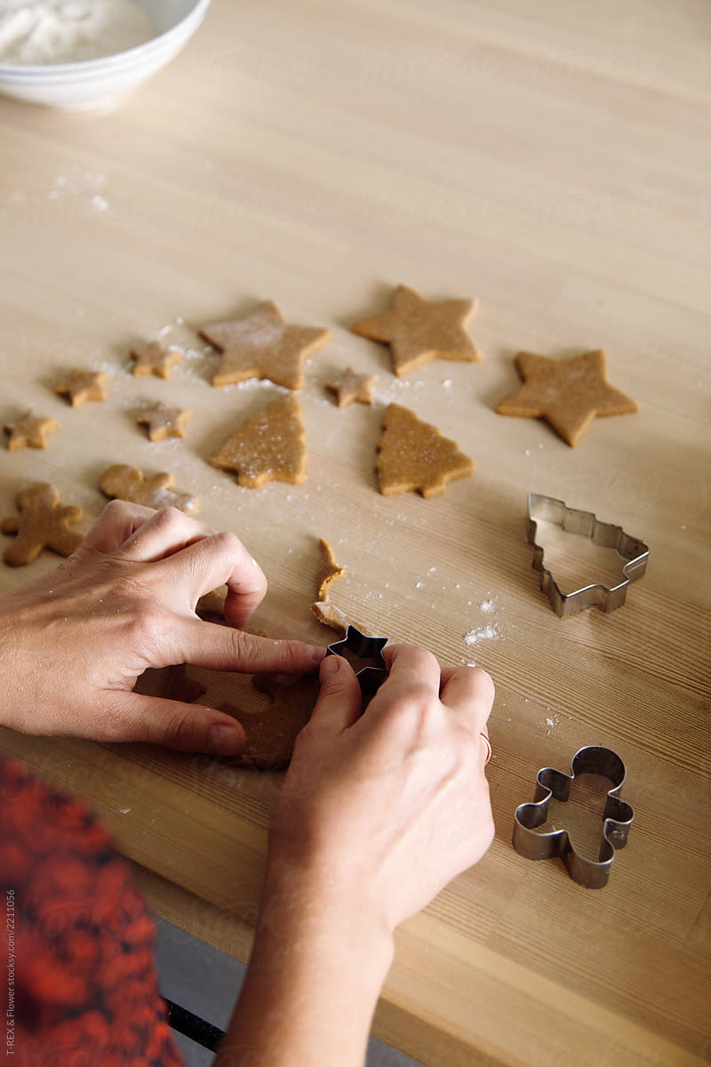 Woman cutting gingerbread cookies out of dough