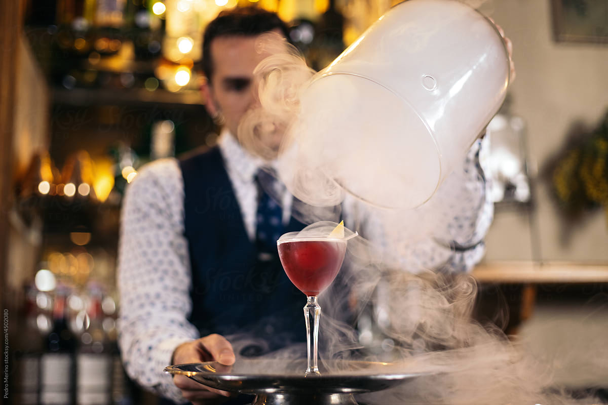 Stylish barman preparing cocktails