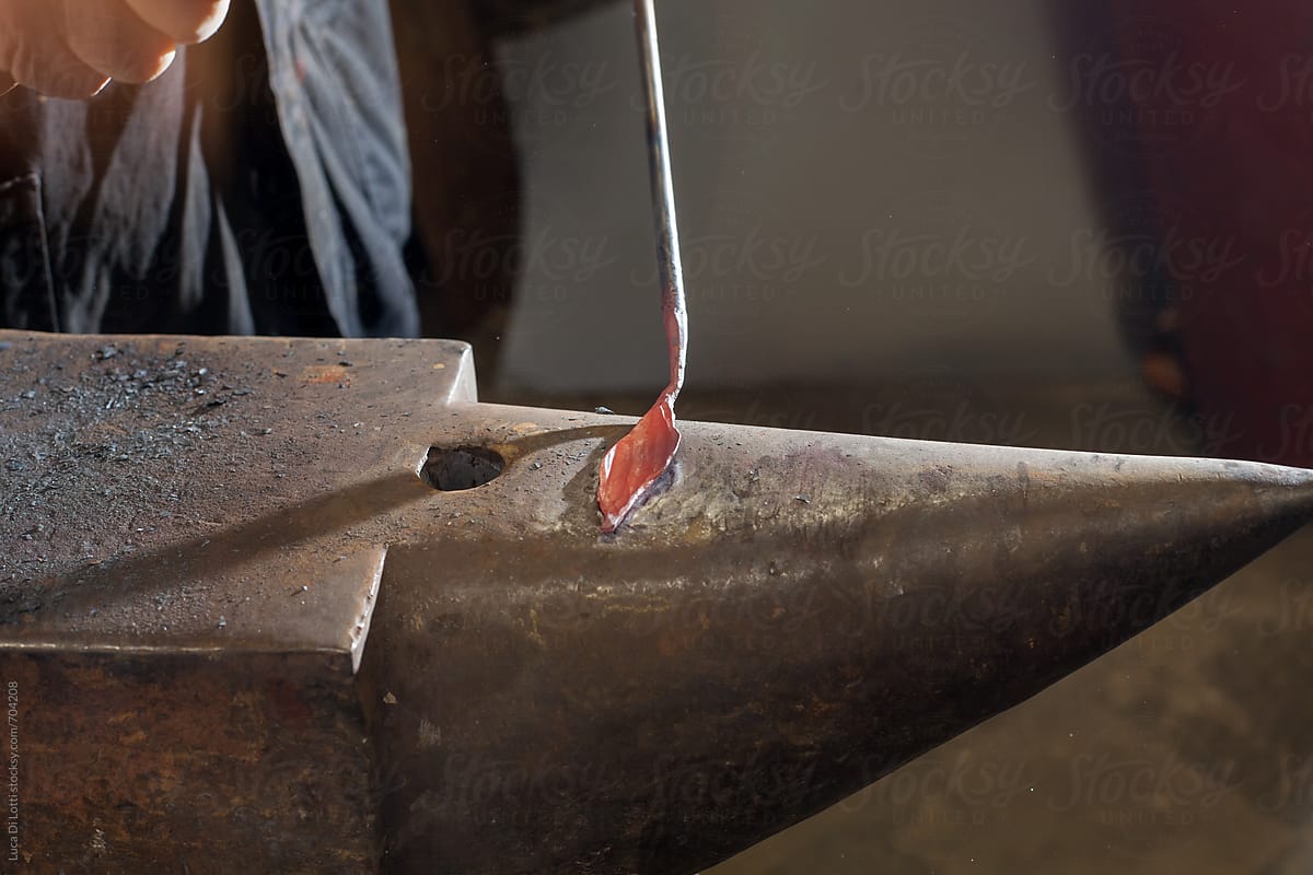 hammered shaped metal leaf on an anvil