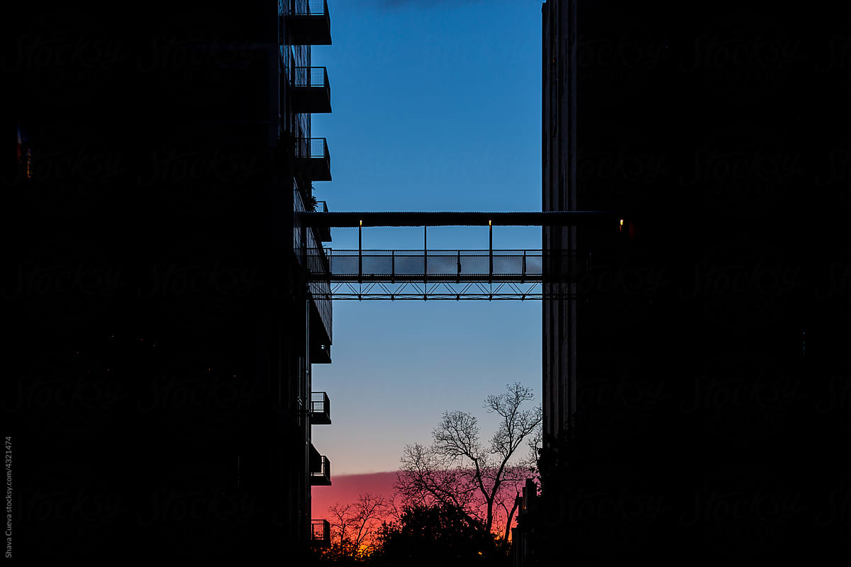 Sunset in the middle of the silhouette of two buildings