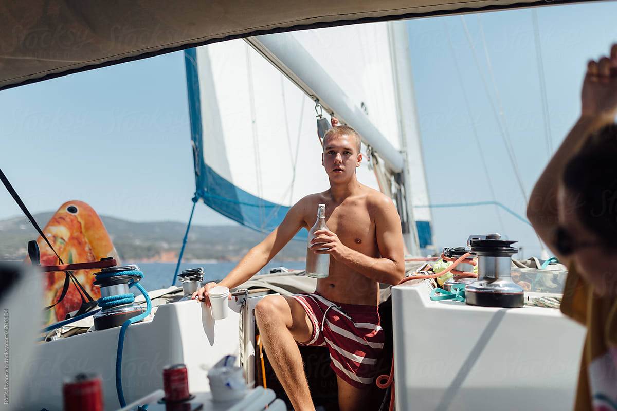 Young Man Drinking Water While Sailing