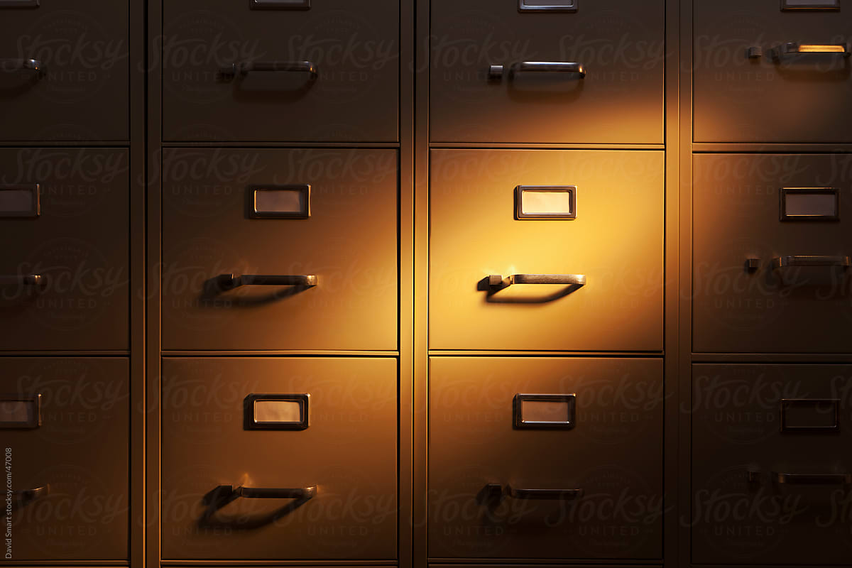 Spotlight shining on a wall of metal filing cabinets