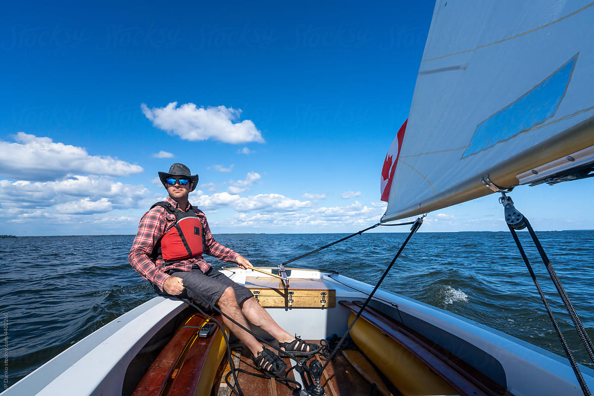 Man Sailing Wayfarer Sailboat on Freshwater Lake