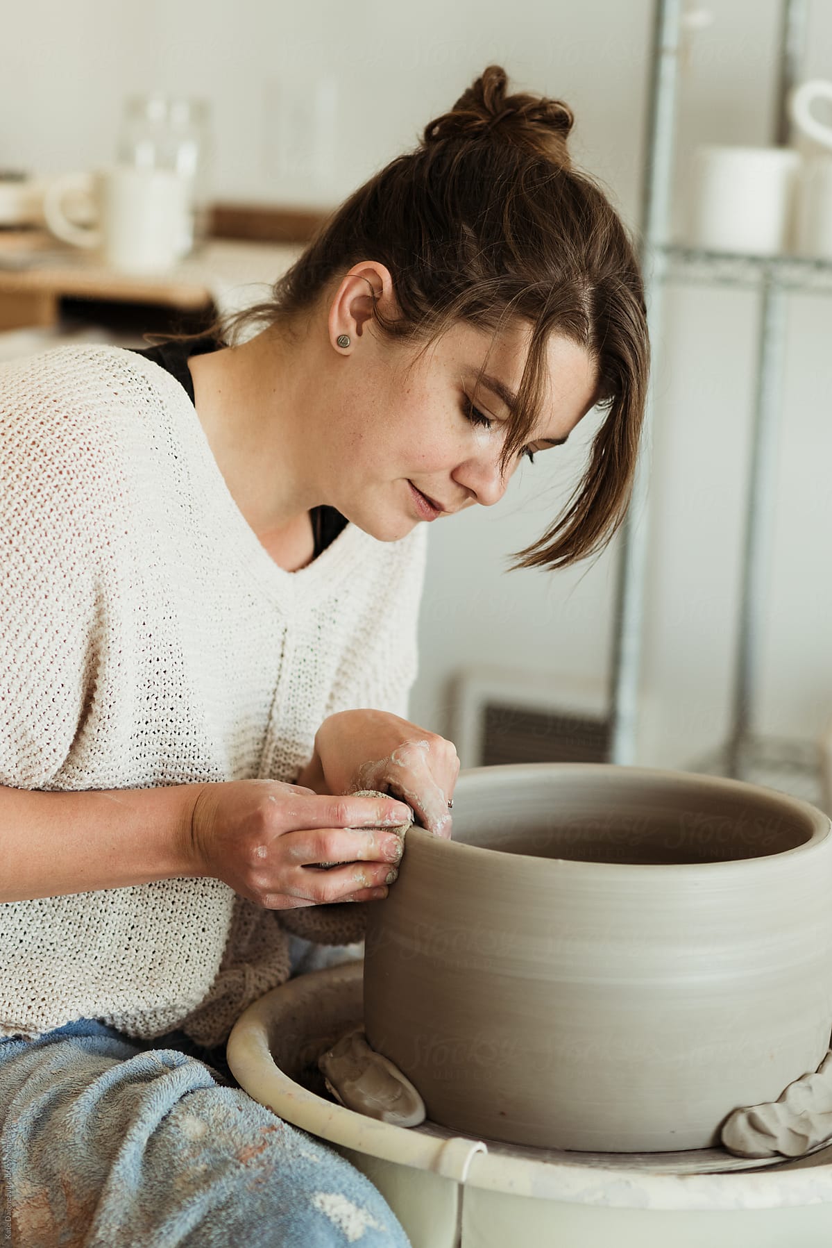 Young female potter working in her  studio