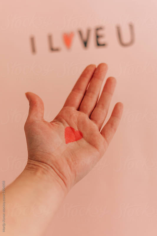 Red heart on a female hand