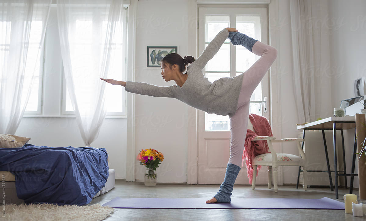 Asian Woman Doing Yoga At Home By Lumina
