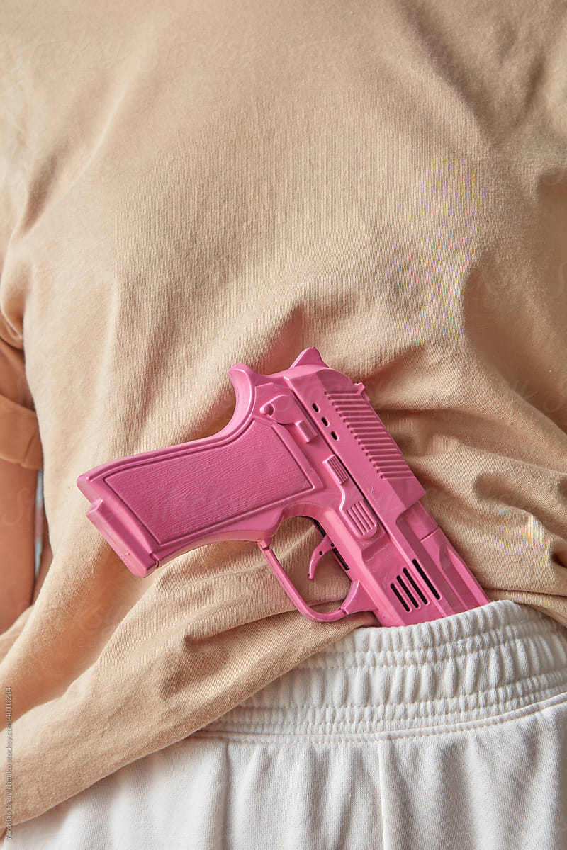 Woman with pink gun on waistband