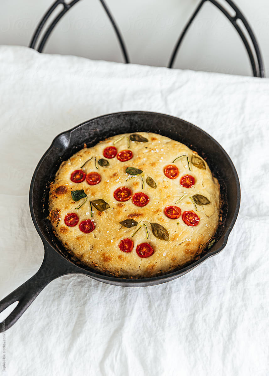 Baked cherry tomato bread in cast iron pan