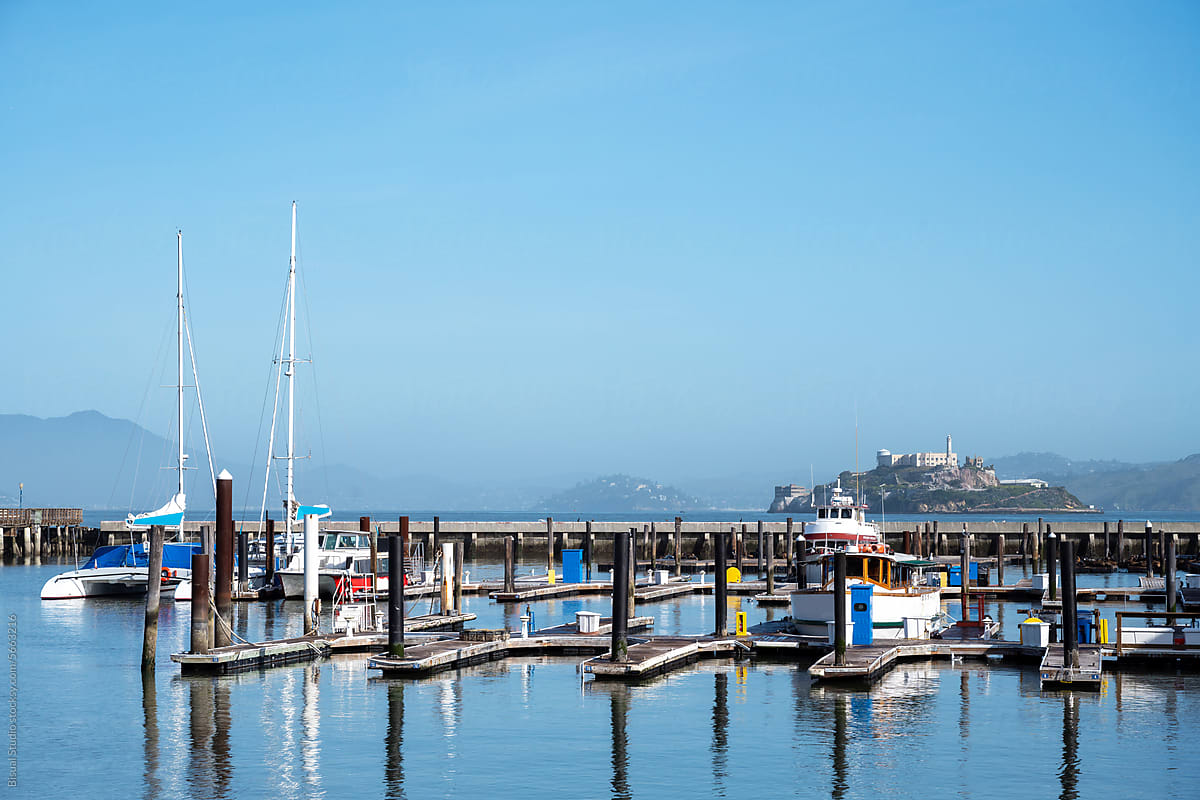 Boats on a pier of San Francisco with Alcatraz Island on the back