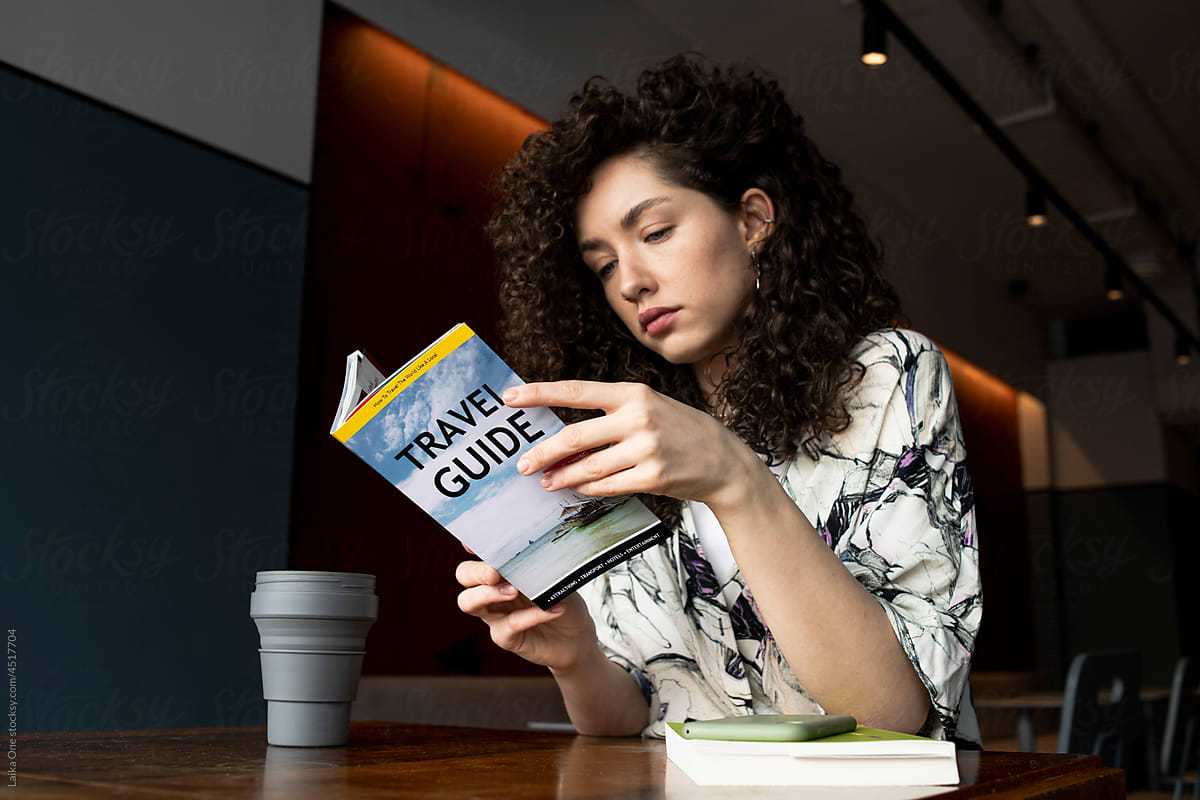 Woman with book sitting in cafe