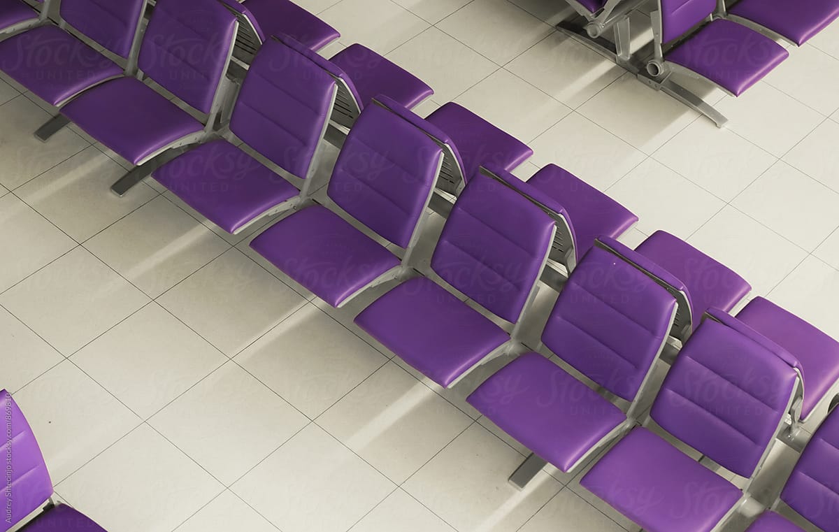 Row of purple chairs in waiting hall