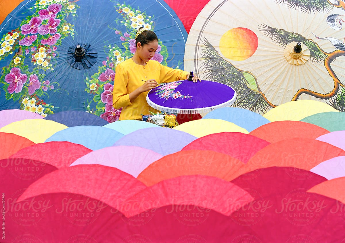 Woman painting umbrellas, Bo Sang umbrella village, Chiang Mai, northern Thailand, Asia