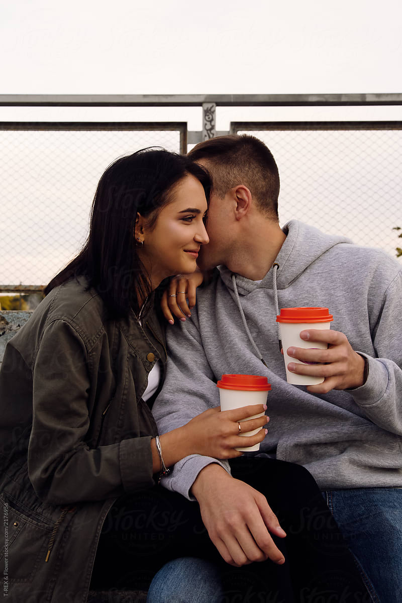 Young beautiful couple drinking coffee and talking