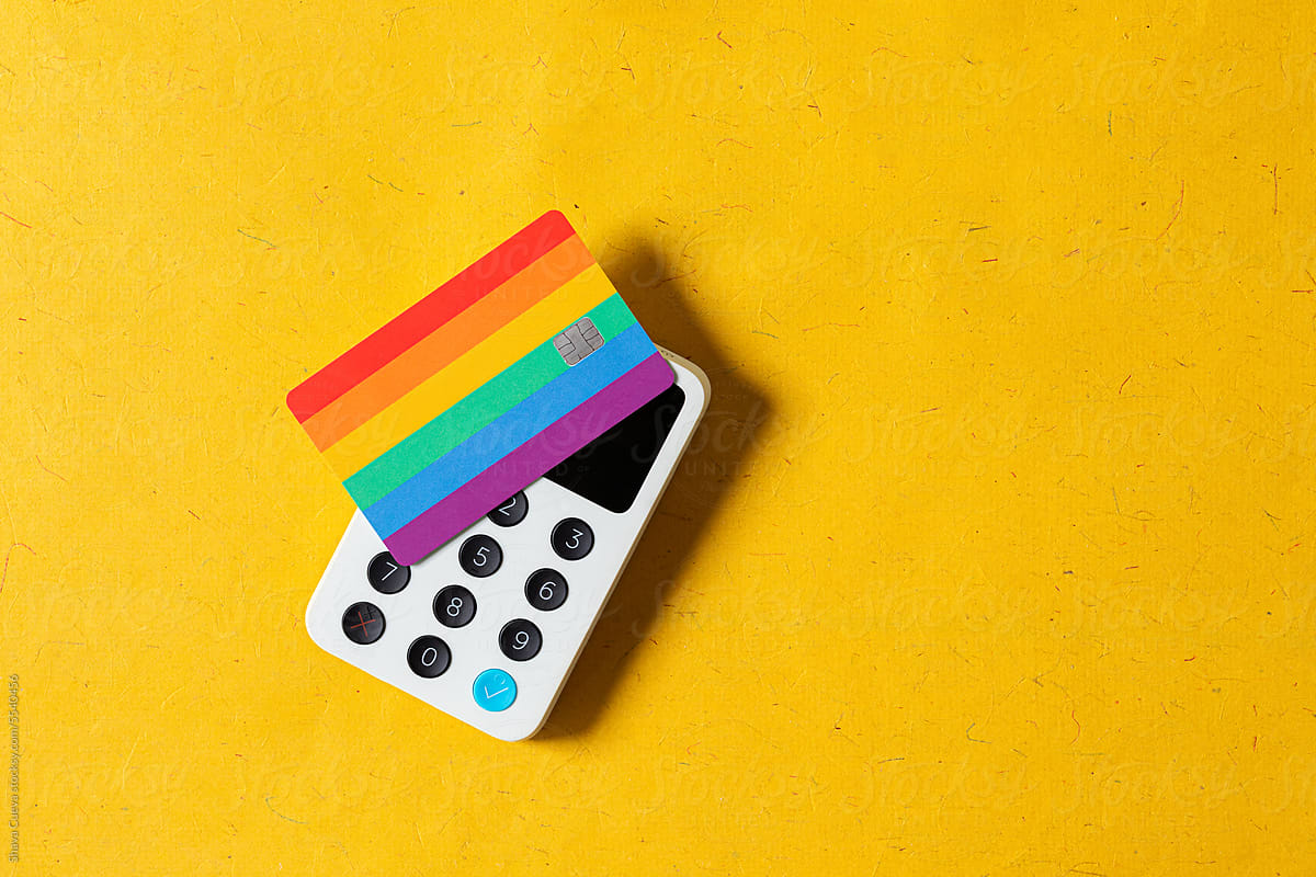Credit card with LGBTQ colors on a white wireless terminal