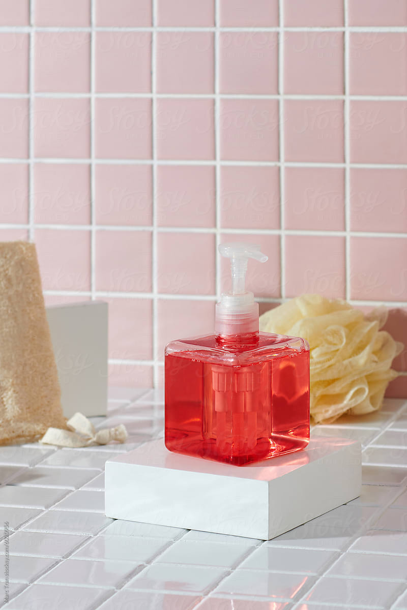 Shower gel, bath sponge, loofah on white table near  in bathroom