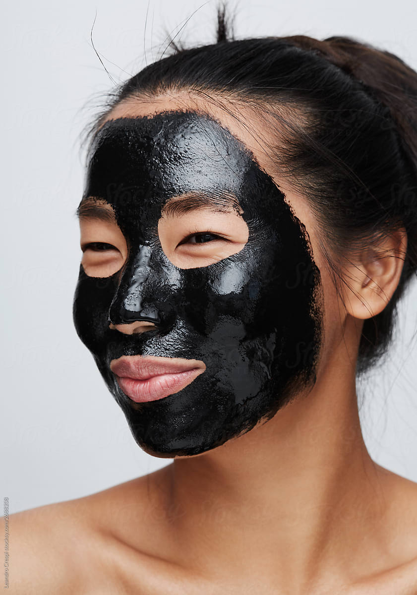 Woman using charcoal mask