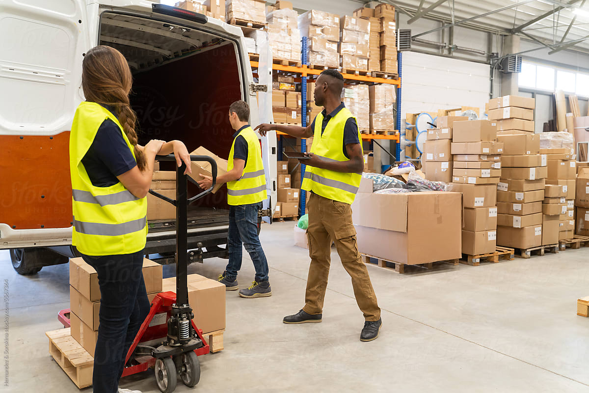 Warehouse Workers Loading Delivery Van Indoors
