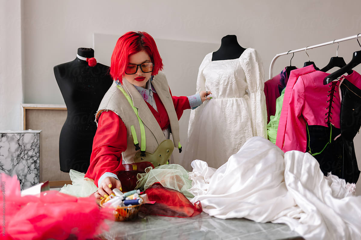 Female creative designer dressmaker making wedding dress
