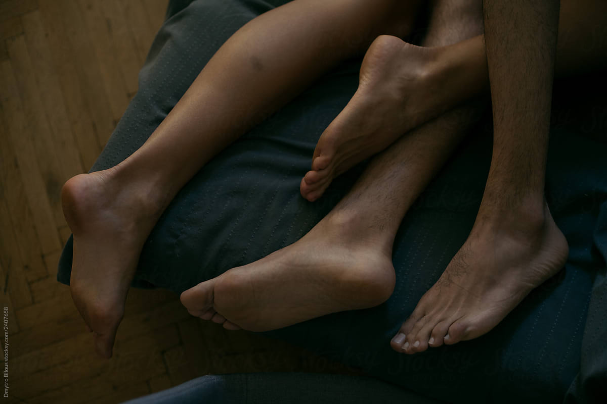 legs of a guy and a girl on a blanket
