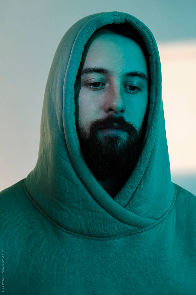 Close portrait of a hooded man with a beard