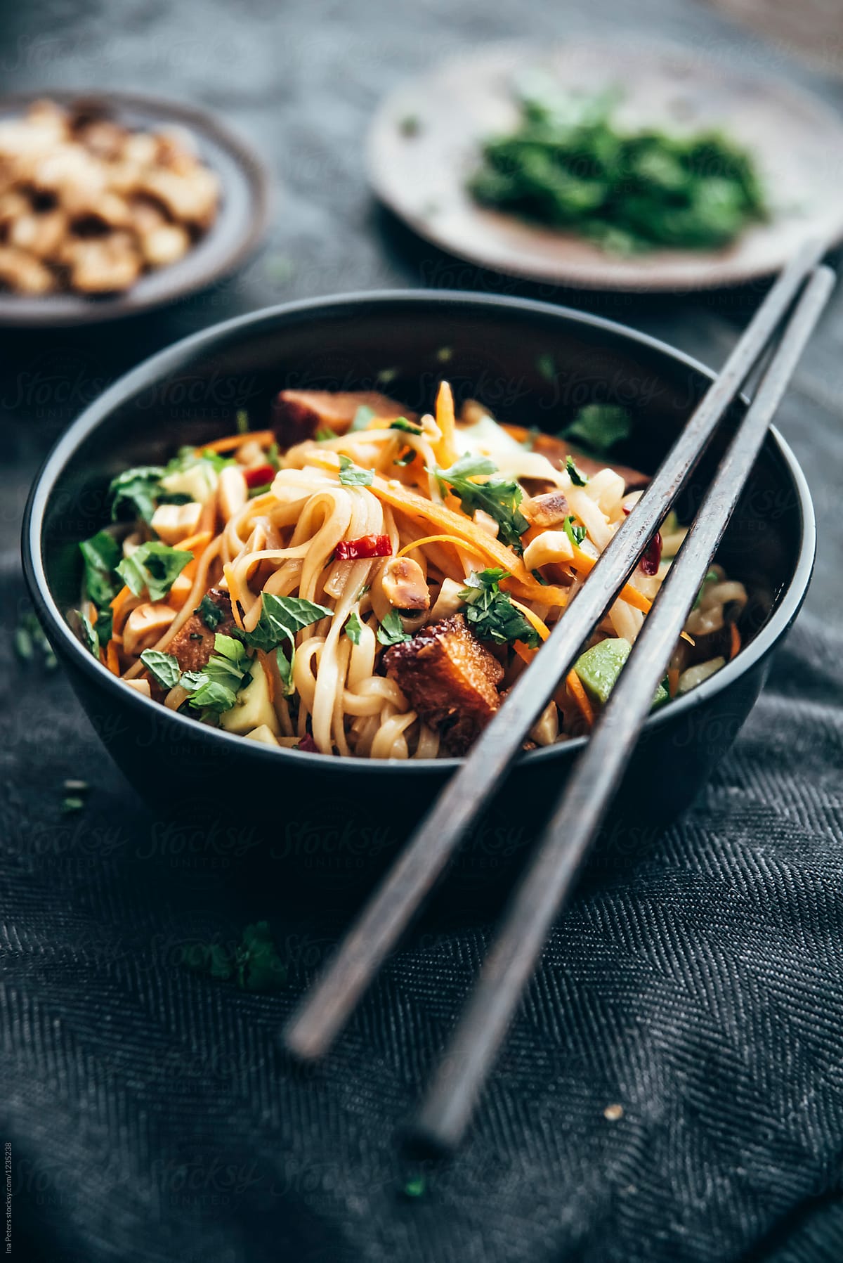 Food: Asian rice noodles with vegetables, tofu, herbs and peanut