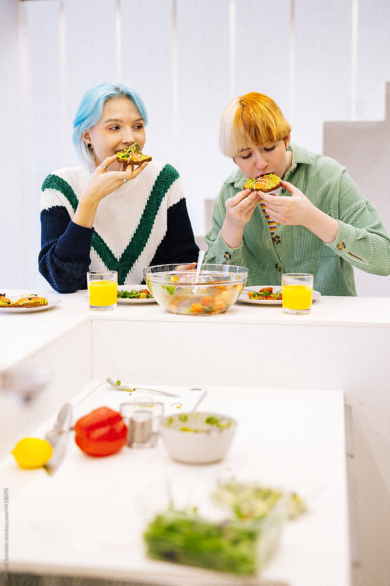 Girls having healthy lunch in kitchen