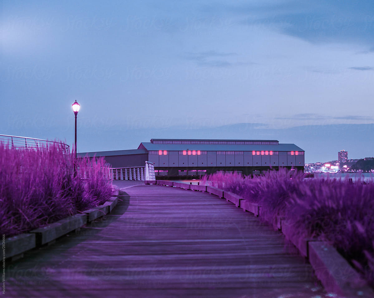 Surreal Purple Building on Boardwalk at Night