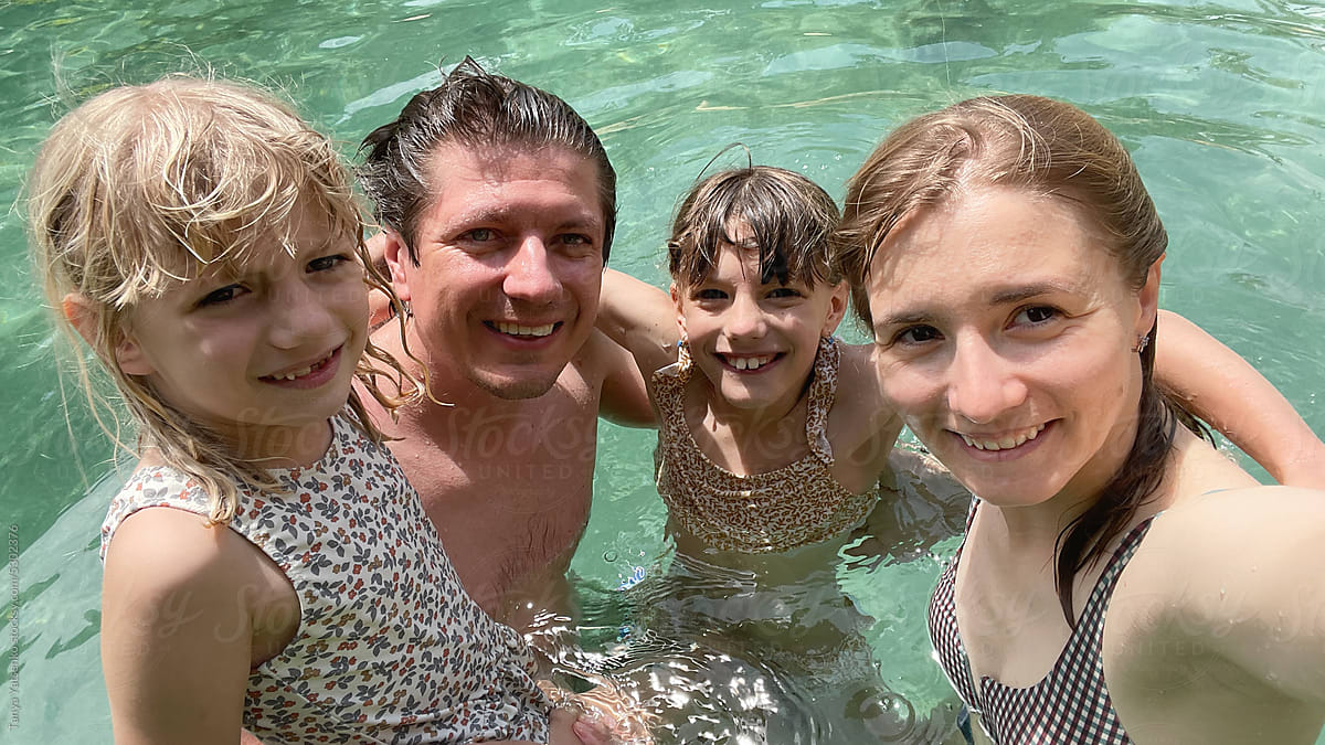 Family selfie photo in the clear water